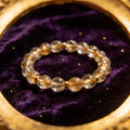 Gold Rutilated Quartz natural stone bracelet on dark velvet