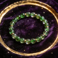 Green Rutilated Quartz natural stone bracelet on dark velvet